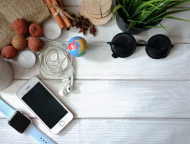 Top view Workspace of a creative person with a phone, notepad, clock and decor, copy space