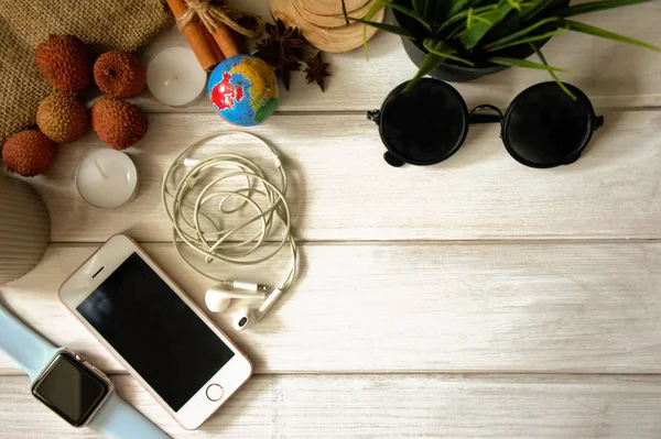 Top view Workspace of a creative person with a phone, notepad, clock and decor, copy space