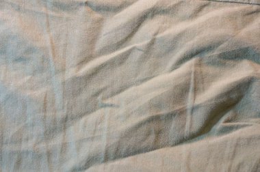 Arkaplan ve harfler için buruşmuş bej kumaş dokusu