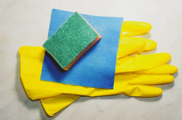 yellow protective rubber gloves, sponge and dishcloth, cleaning service symbol