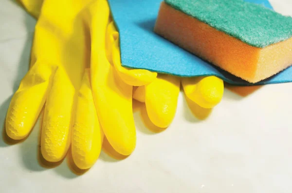 yellow protective rubber gloves, sponge and dishcloth, cleaning service symbol