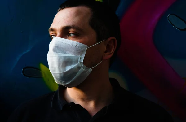 Protection against infectious diseases, coronaviruses. Man wearing a hygiene mask to prevent infections, respiratory diseases such as flu and COVID-19