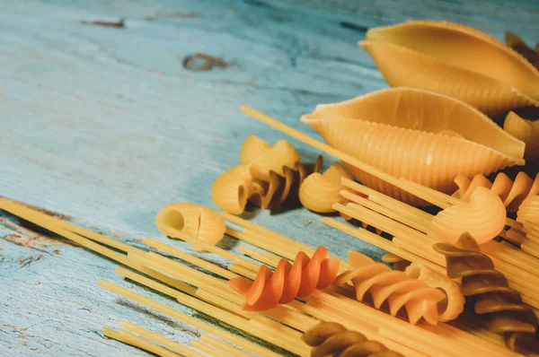 Berbagai Jenis Pasta Pada Kayu Latar Belakang Warna Biru Farfalle — Stok Foto