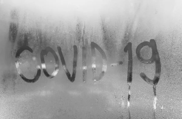コロナウイルス19の銘が霧の窓に刻まれているのは呼吸とウイルスへの抵抗の象徴です — ストック写真