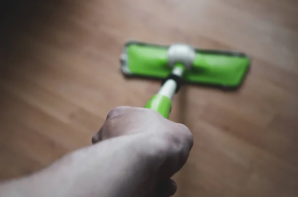 Man Washes Dark Wooden Floor Green Mop House Cleaning Concept — Stock Photo, Image