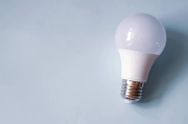 LED light bulb on a blue background with place for your text