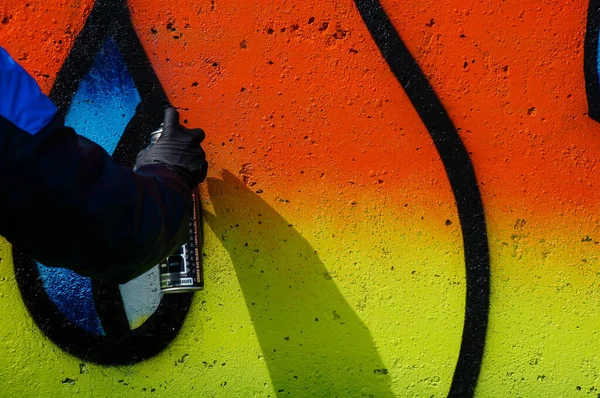 街头艺术家在一面普通的墙上画上五彩斑斓的涂鸦 现代艺术概念 在墙上用喷雾器喷漆 — 图库照片