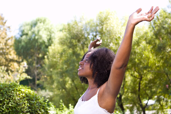 All natural African American woman outside in nature.