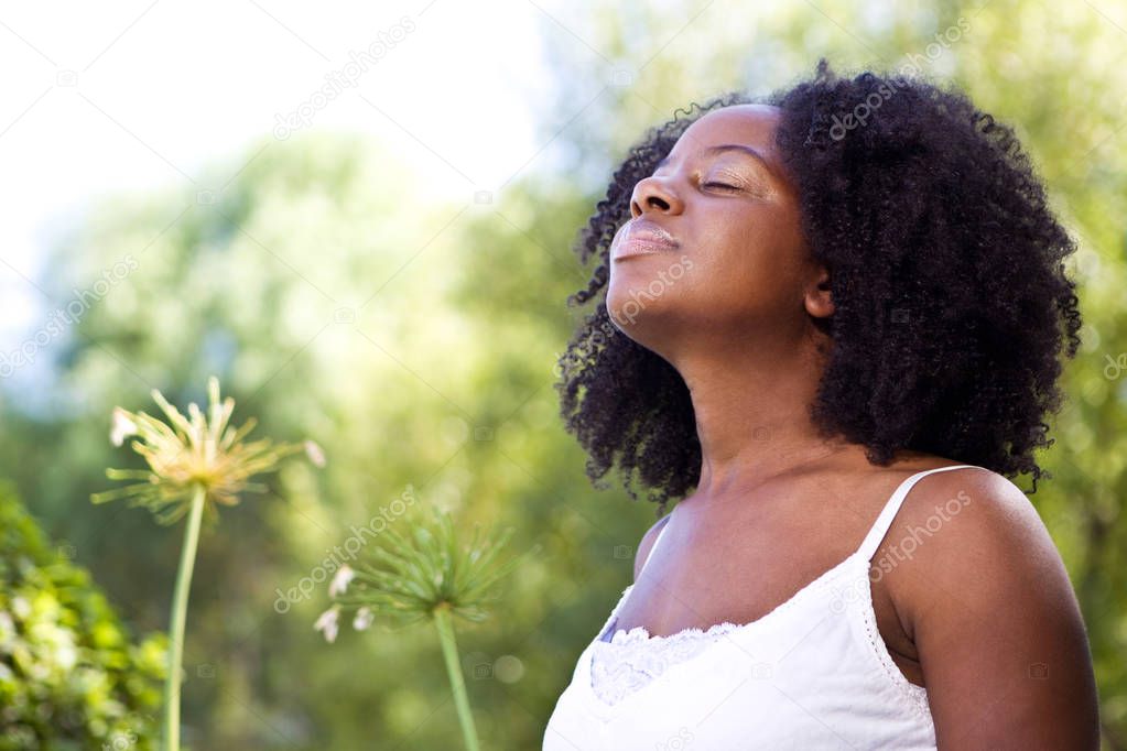 Confident African American woman outside in a garden.