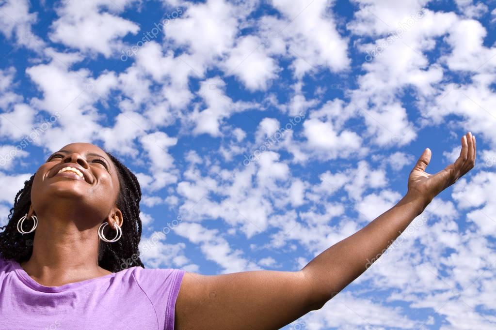 Happy African American woman with open arms.