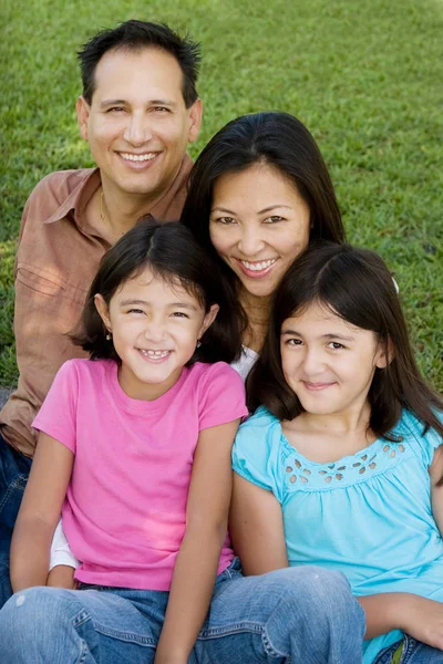 Loving Asain parents and their daughters smiling. — Stock Photo, Image