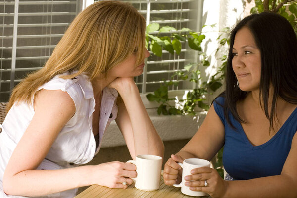 Diverse group of women having coffee and talking.