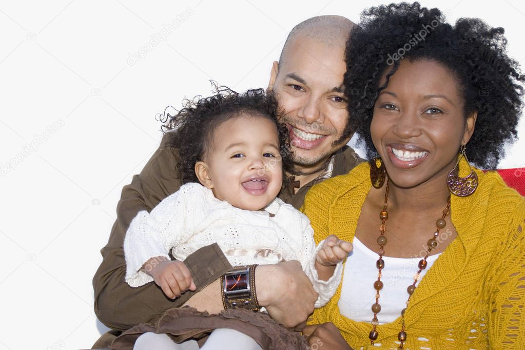 Loving multicultural parents and their daughter smiling.