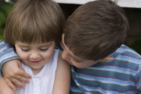 Portrait of a happy brother and sister hugging. — Stock Photo, Image