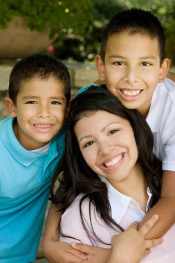 Happy Hispanic mother and her sons. clipart