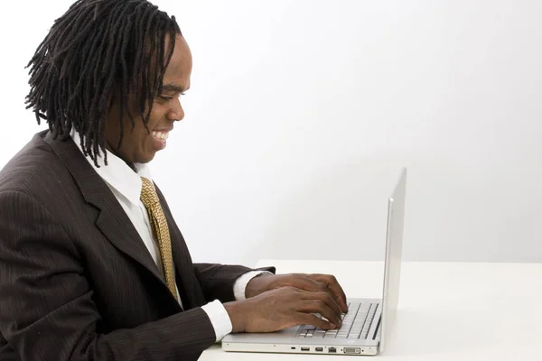 Stylish dreadlocks businessman using a computer. — Stock Photo, Image