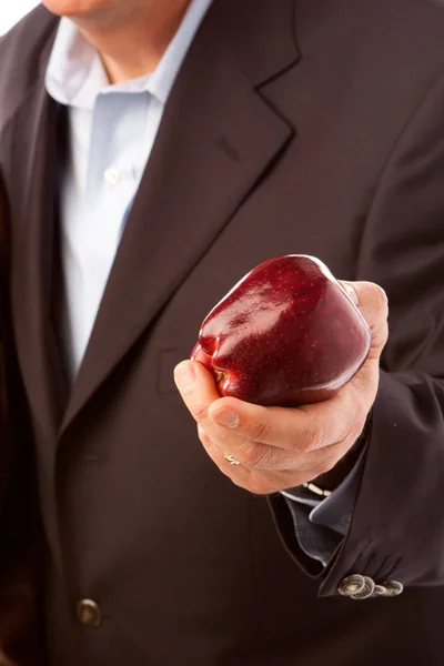 Business man holding an apple isolated on white. — Stock Photo, Image