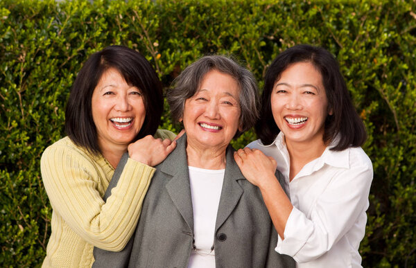 Mature Asian mother and her adult daughters.