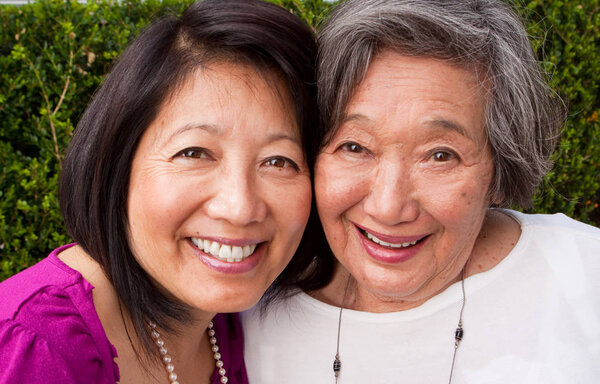Mature Asian mother and her adult daughter.