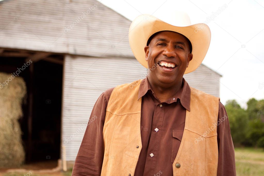 African American cowboy smiling and laughing.