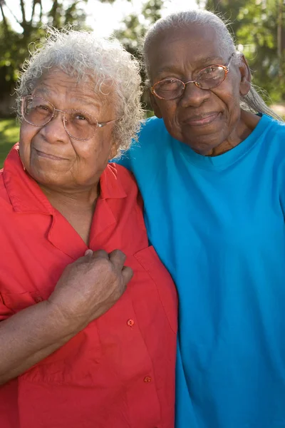 Happy mature African American sisters laughing and smiling. — Stock Photo, Image