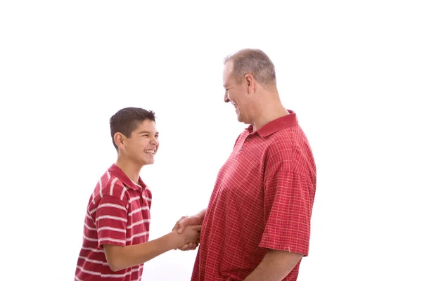 Happy Hispanic father and son shaking hands. Stock Picture