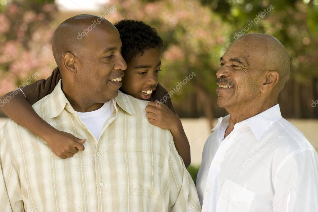 Grandfather with his adult son and grandchild.
