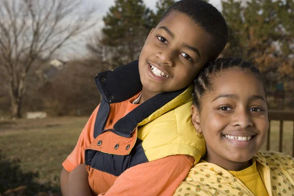 Happy African American brother and sister smiling. — Stock Photo, Image