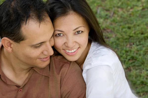 Portrait of an Asian couple laughing and hugging. — Stock Photo, Image