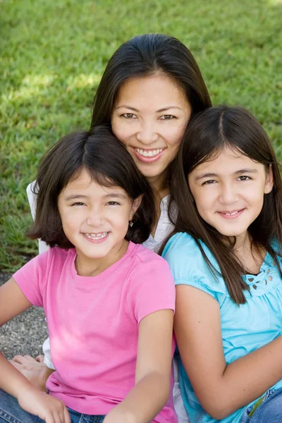 Loving Asain mother and her daughters smiling. — Stock Photo, Image