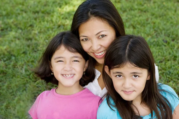 Loving Asain mother and her daughters smiling. — Stock Photo, Image