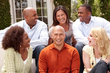 Multi ethnic group of people smiling outside. clipart