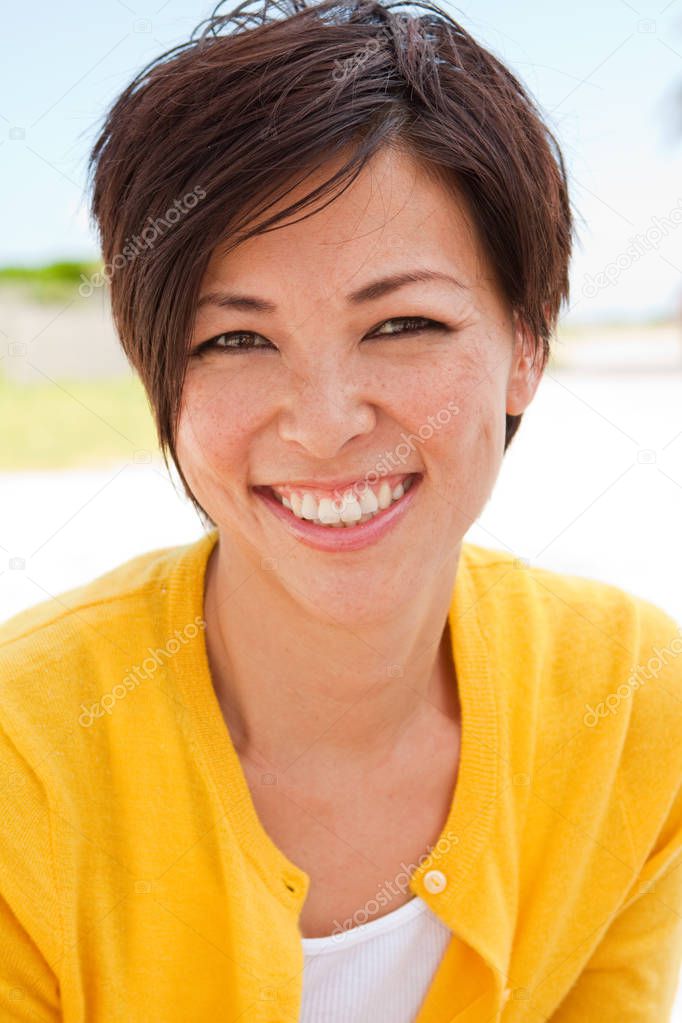 Happy Asian woman smiling at the beach.
