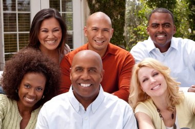 Multi ethnic group of people smiling outside. clipart