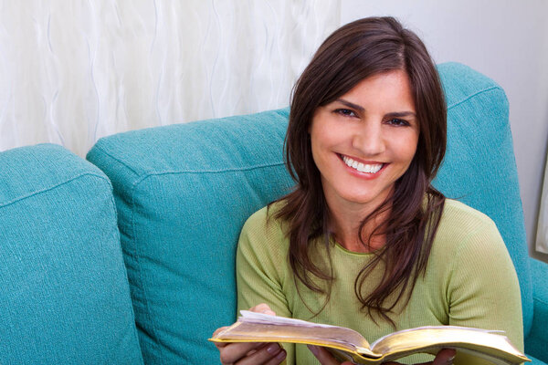 Smiling woman at reading a book.