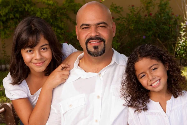 Happy Hispanic family laughing and smiling.