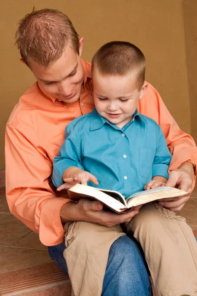 Happy loving father reading with his son. — Stock Photo, Image