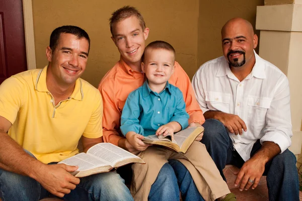 Mens Group Bible Study. Father reading the bible with his son.