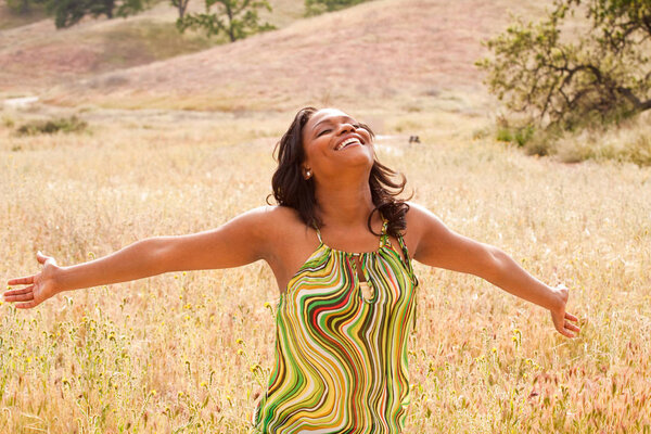 Женщина в поле с распростертыми объятиями
.