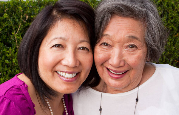 Mature Asian mother and her adult daughter.