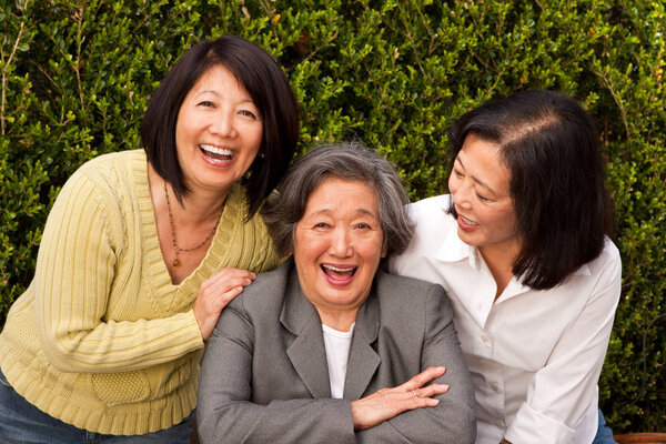 Mature Asian mother and her adult daughters.