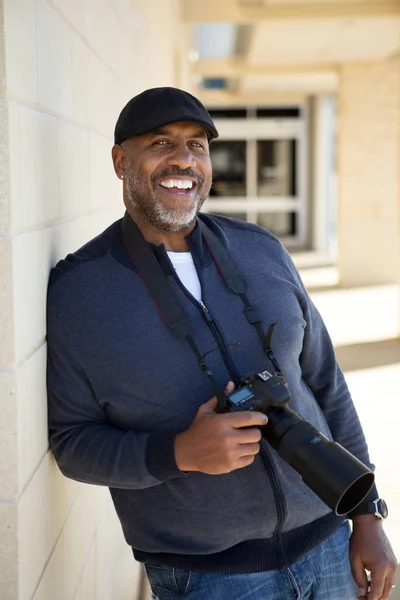 アフリカ系アメリカ人の男がカメラを持って笑みを浮かべて — ストック写真