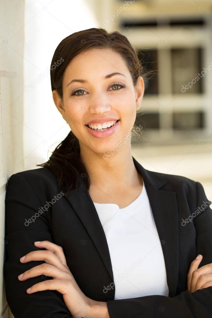 Business woman standing outside an office building.
