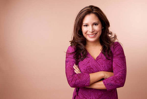 Beautiful Hispanic woman smiling looking at the camera.