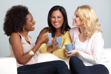 Diverse group of friends having coffee and talking. clipart