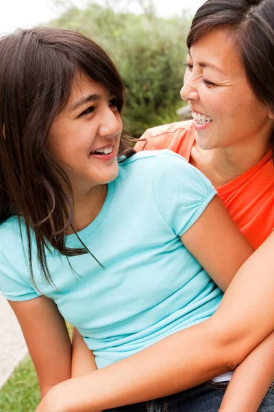 Loving Asian mother and daughter smiling. Stock Picture