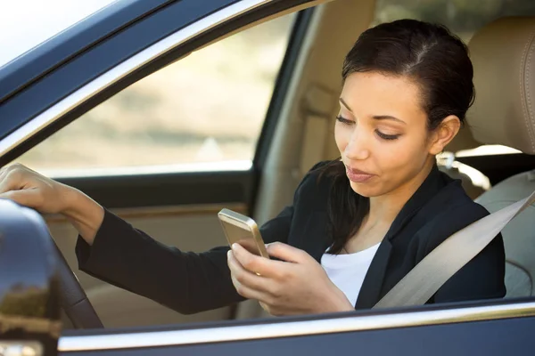 Business woman talking on her mobile phone and driving.