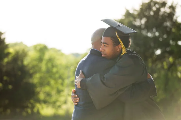 Father hugging his son at his graduation. — Stock Photo, Image
