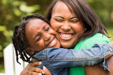 Happy African American mother and daughter. clipart