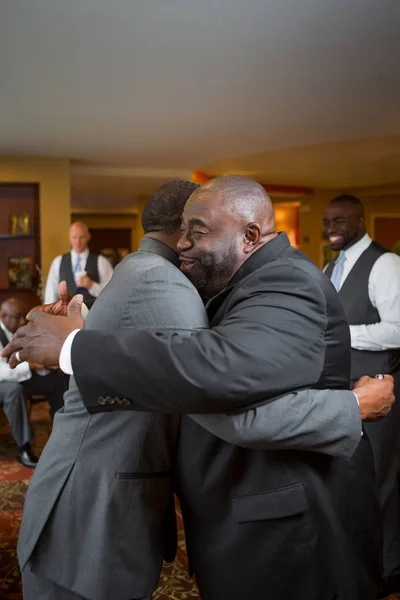 Father and hugging her adult son at his wedding. — Stock Photo, Image